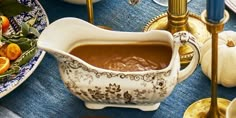 a bowl filled with liquid sitting on top of a blue table cloth covered tablecloth