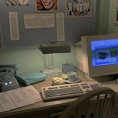 a desk with a computer, keyboard and mouse on it in front of a monitor