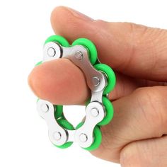 a hand holding a pair of scissors in the shape of a flower on a white background