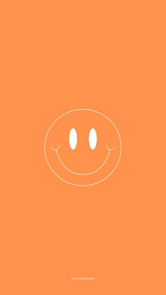 an orange background with a smiley face drawn in the center and two white dots on top