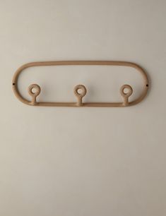 three wooden hooks hang on the wall