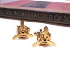 These cufflinks are made with moveable raw brass air plane propellers.  The base measures 1/2" in diameter by 1/8" tall and the blades are 3/4" in diameter (5mm x 10mm x 21mm). They are soldered to gold plated cuff links. Please note that these are raw brass and will develop a patina over time.  If you wish them to go back to their shiny gold appearance, simply buff with a polishing cloth. If you'd like more for a wedding party or another special occasion please contact me!