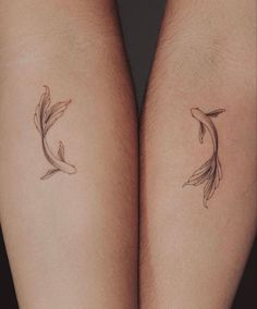 two fish tattoos on both legs