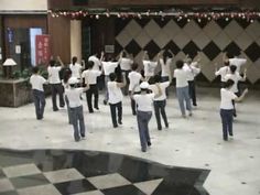 a group of people standing on top of a checkered floor