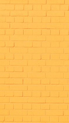 a yellow brick wall with a stop sign on it