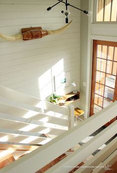 an overhead view of a room with white walls and wood floors