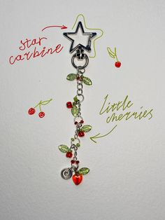 a keychain with charms attached to it and writing on the wall behind it