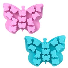 two butterfly molds sitting next to each other on a white surface, one is pink and the other is blue