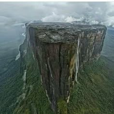 an aerial view of a waterfall on top of a mountain