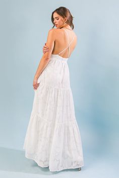 A textured woven maxi dress featuring surplice cami top, tiered skirt, bare back with criss-cross straps and back zipper closure Details Self: 100% Polyester Lining: 100% Polyester Size & Fit - Model is 5`8" And Wearing Size Small - Measurements Taken From Size Small - Approx. Length: 50" White Graduation Dress Long, White Beach Dresses, Confirmation Dresses, Beach White Dress, Bachelorette Party Dress, Senior Photo Outfits, Hoco Dress, Champagne Dress, Rehearsal Dinner Dresses