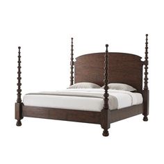 a bed with four posts and white sheets