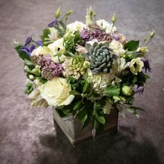 a vase filled with white and purple flowers