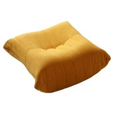 a yellow pillow sitting on top of a white floor