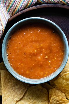 a bowl of salsa with tortilla chips on the side