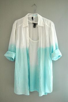 a white and blue shirt hanging on a wall