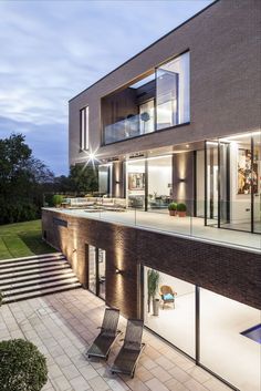 House on sloped site with dug in basement patio and brick walls Moroccan Summer, Doors Aluminium, Frameless Glass Balustrade, Minimal Windows, Aluminium Sliding Doors, Sliding Door Systems, Double Height, Glass Balustrade, Extension Ideas