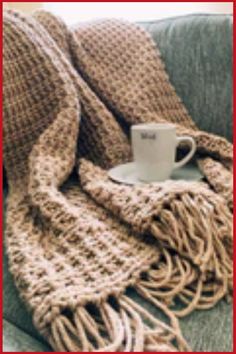 Cozy knit blanket draped over a couch with a coffee mug on a saucer. Easy Chunky Crochet Blanket, Easy Crochet Blanket For Beginners, Crochet Blanket For Beginners, Hobby Corner, Tunisian Crochet Blanket, Chunky Crochet Blanket Pattern, Chunky Crochet Blanket, Easy Crochet Blanket, Crochet Blanket Designs