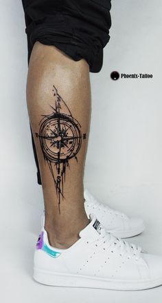 a person with a compass tattoo on their leg