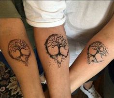 two people with tattoos on their arms and feet, one has a tree in the shape of a heart