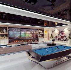 a pool table in the middle of a room with couches and televisions behind it