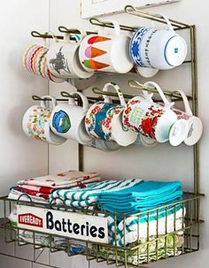 a rack with cups and mugs hanging on it