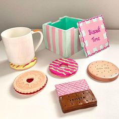 there are different types of doughnuts on the table next to a coffee cup