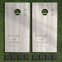 two personalized cornhole game boards on the grass