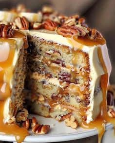 a cake with pecans and caramel drizzled over it on a plate