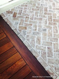 a wooden floor with a brick pattern on it and a door in the back ground