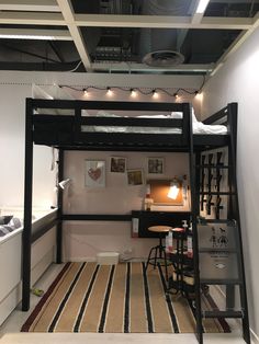 a loft bed with a desk underneath it