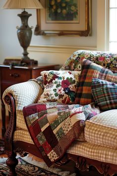 a couch with many pillows on it in front of a lamp and painting above the couch