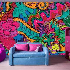 a living room with colorful wallpaper and furniture