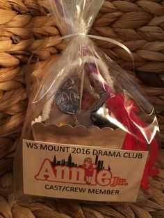 a bag with some items in it sitting on a woven basket next to a wicker basket