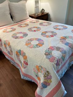 a bed with a quilt on top of it