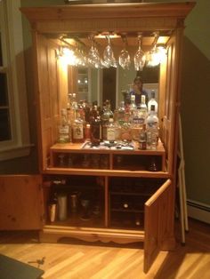 a wooden cabinet filled with lots of bottles