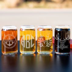 four different types of beer are lined up on a table