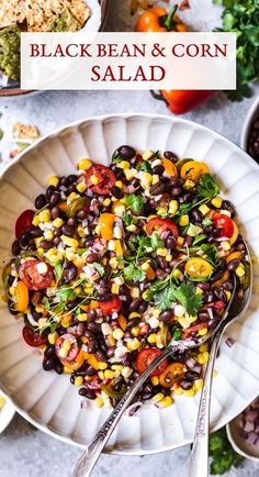 black bean and corn salad on a white plate with silverware next to other dishes