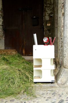 a white box filled with lots of green grass