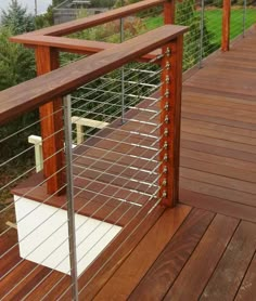 a wooden deck with metal rails and railings