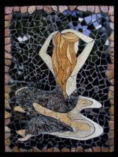 a woman with long hair is depicted on a mosaic tile wall in the shape of a mermaid