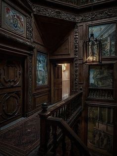 an old wooden staircase with paintings on the walls