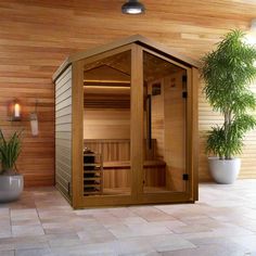 an indoor sauna is shown with potted plants