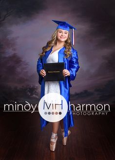 a young woman in graduation gown and cap posing for a photo on a wooden floor