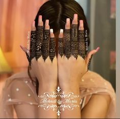 a woman with her hands on her face covered by hendis and lace nails