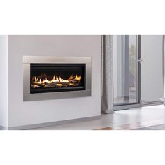 an electric fire place in the corner of a room with glass doors and white walls