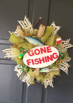 a fish wreath with the words gone fishing on it