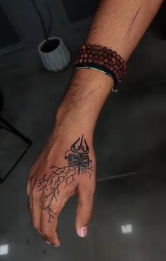 a man's hand with a tattoo on it and a spider crawling out of the middle