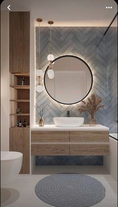 a bathroom that has a round mirror on the wall and a rug in front of it