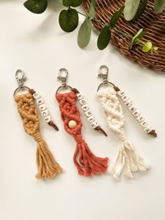 three keychains with different colored tassels on them