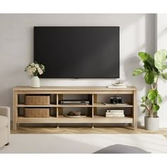 a living room with a large flat screen tv on top of a wooden entertainment center